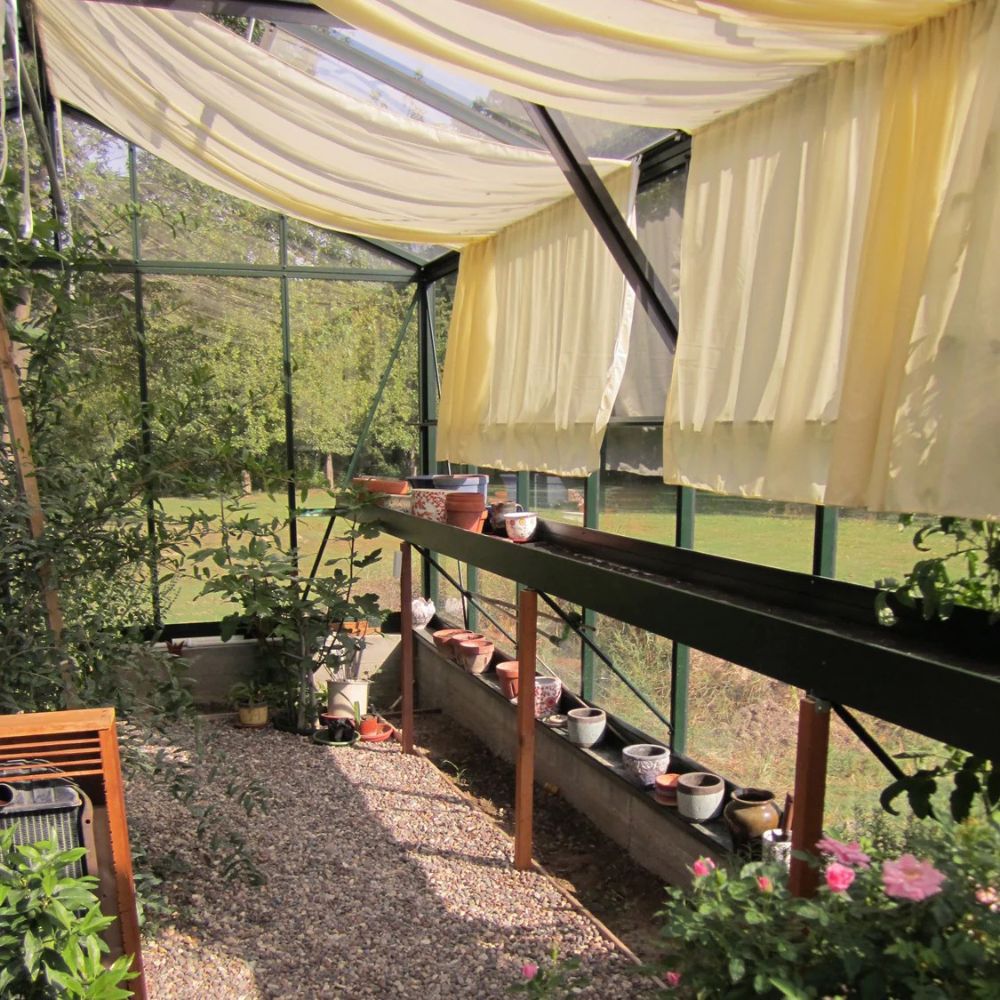 Greenhouse with yellow curtains and potted plants