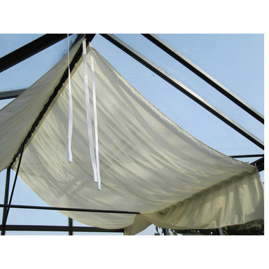 White canopy tent with ropes against a clear blue sky
